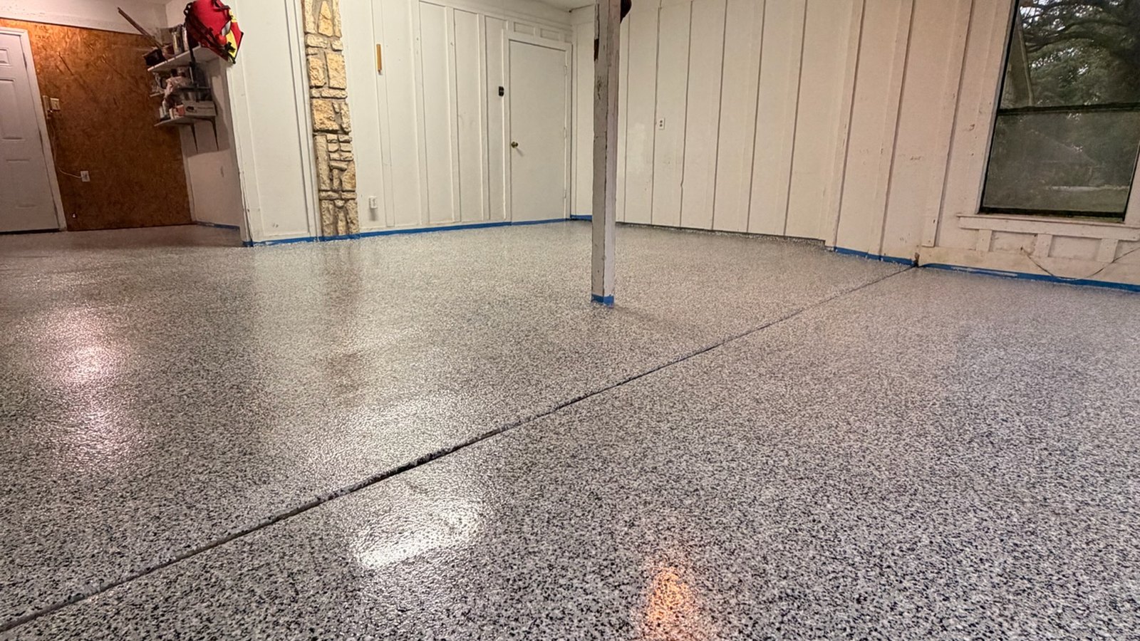 A finished gray flake epoxy garage floor in North Texas, a coating that holds its value