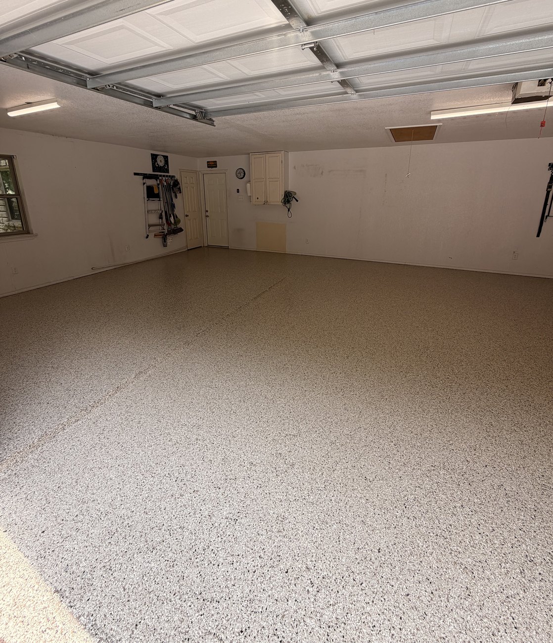 Finished cream flake garage floor in DeCordova after Happy Slab coating