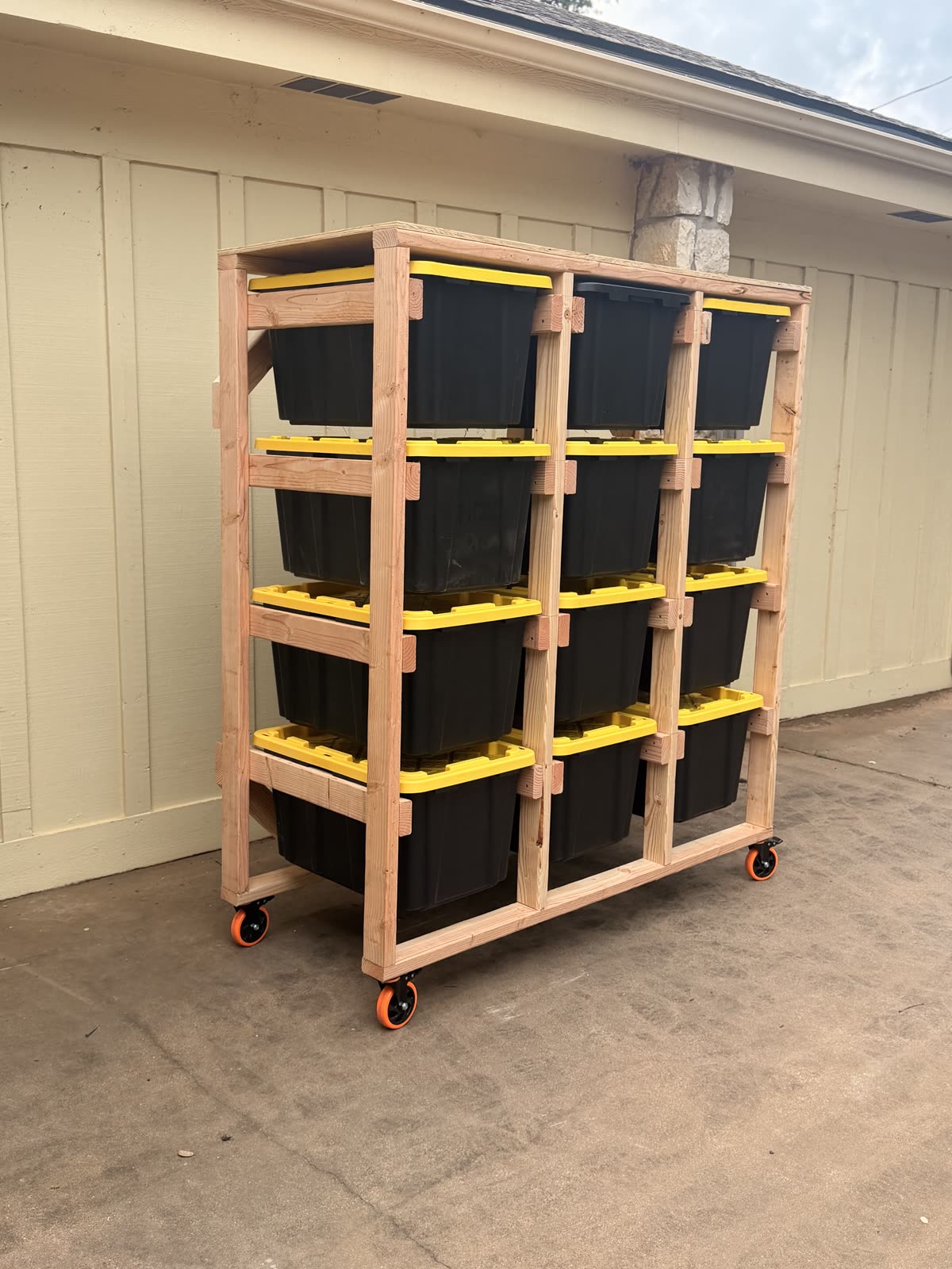 Side angle of a rolling tote rack on locking casters showing the 2x4 rail construction