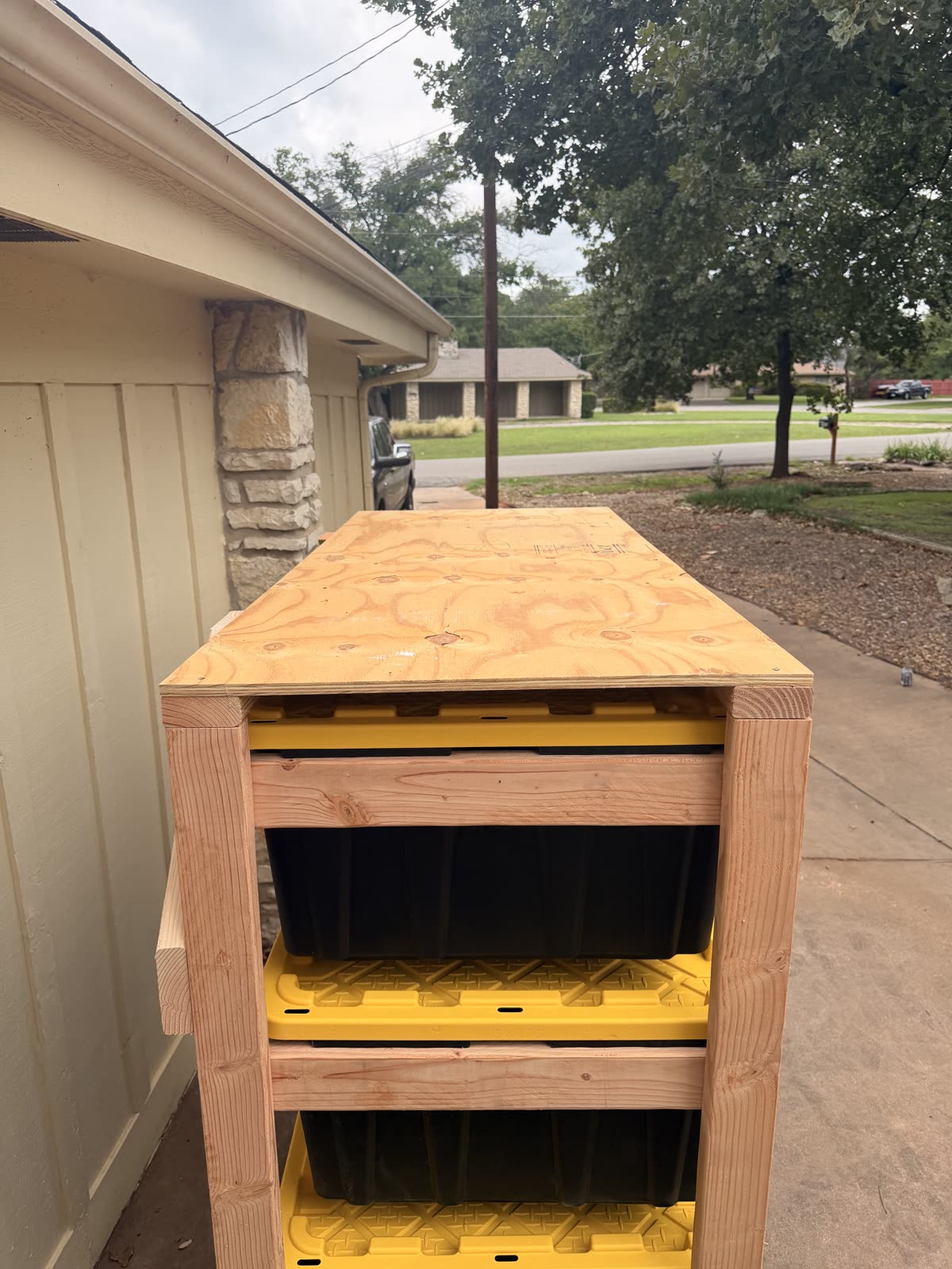 The plywood top surface option on a Happy Slab tote rack, used as a work surface
