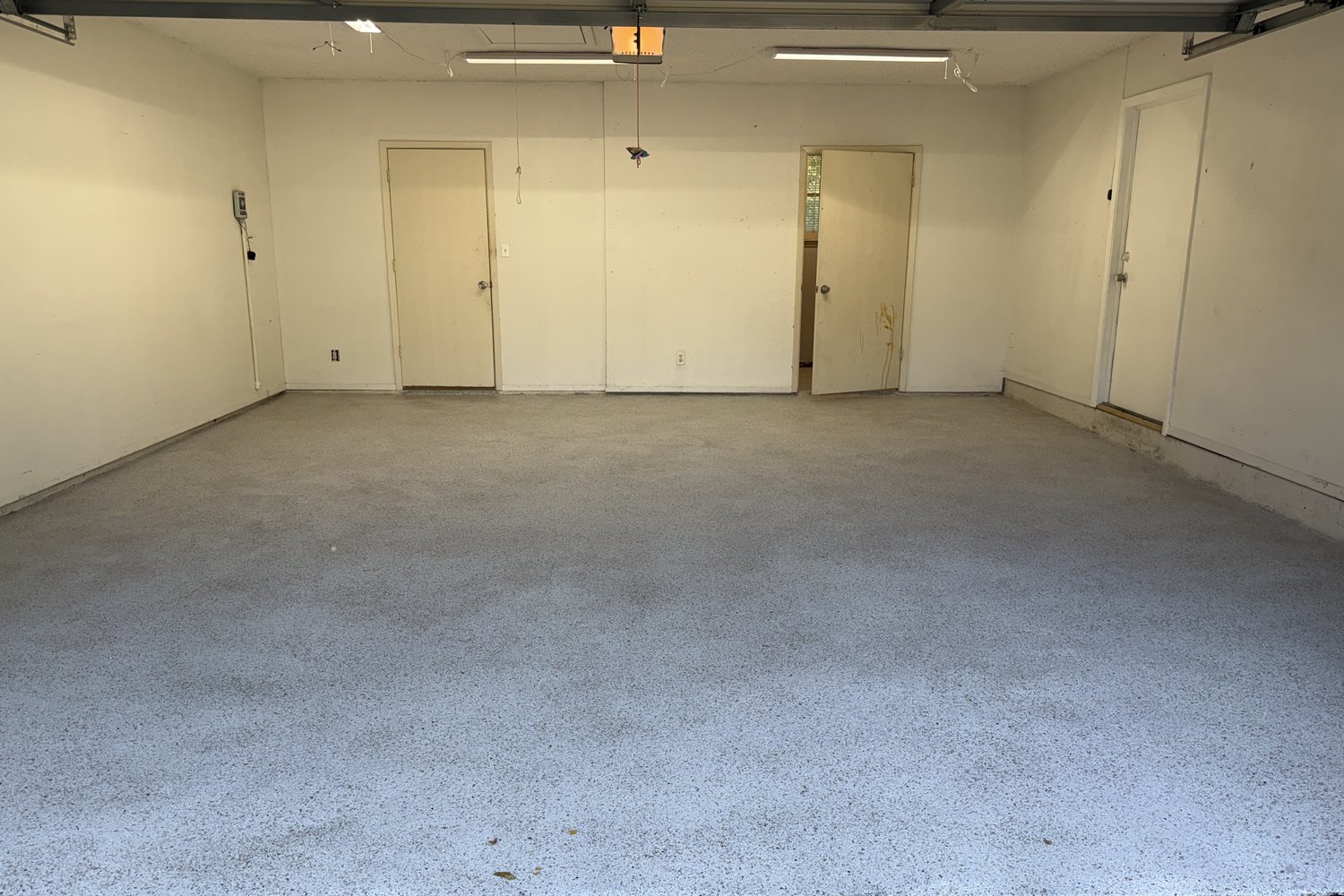 After: two-car garage, stained concrete to tan flake floor
