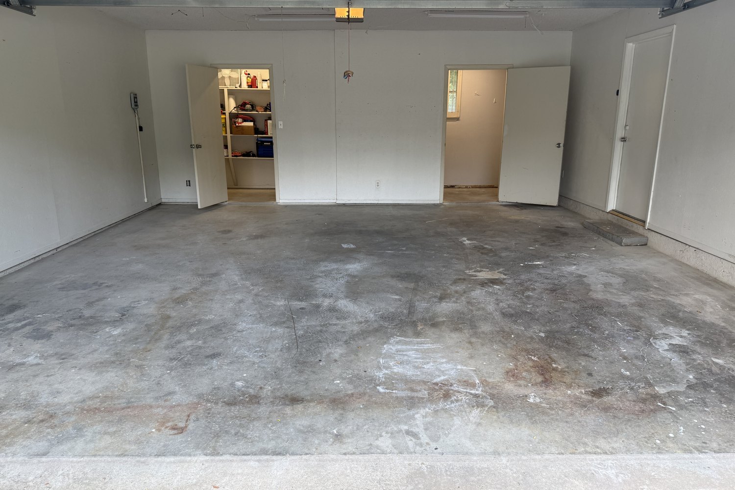Before: two-car garage, stained concrete to tan flake floor