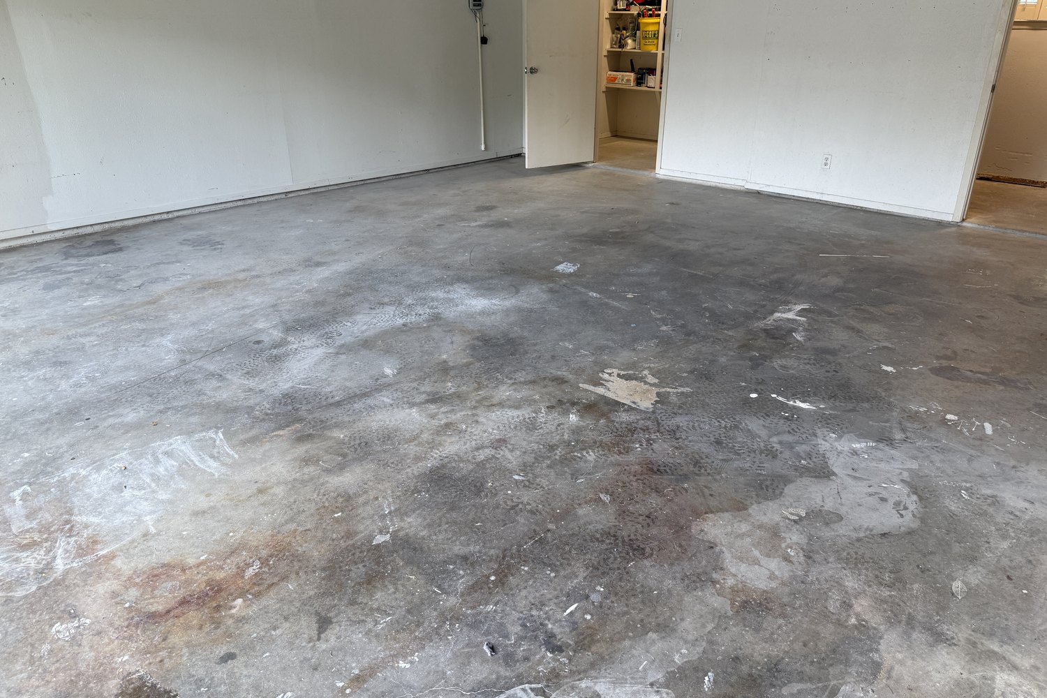 Before: garage floor toward the interior room