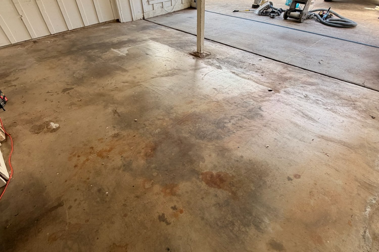 Before: garage looking out the door, stained concrete to Domino flake